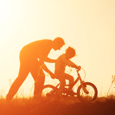 father and daughter riding a bike