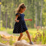 little girl on a log